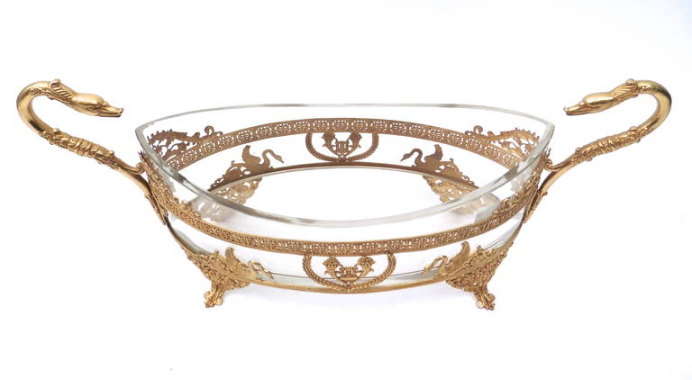 A very fine French ormolu and glass oval tabletop jardiniere, circa 1890. The pierced frame decorated with swans on either side and central lyre framed by laurel wreaths. Supported on four acanthus and floral motif feet, with two handles formed as