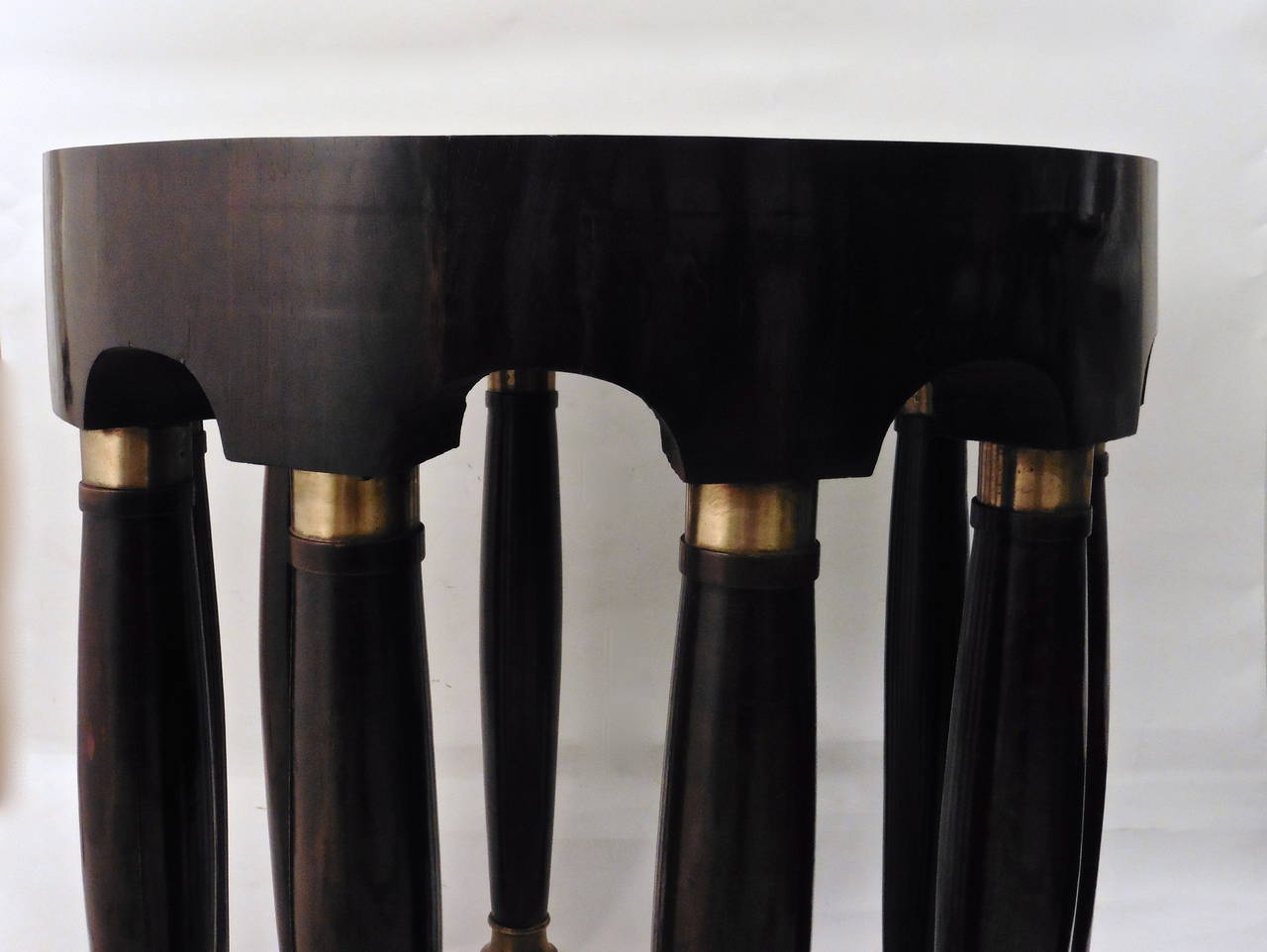 A wonderful Austrian Secessionist movement elephant table, attributed to Adolf Loos, circa 1900. The circular polished rosewood top above a Portico Frieze, supported by ten elegantly designed column legs with brass mounts.