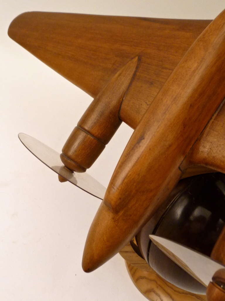 English Carved Wood Model of a Twin Engine Plane on a Globe Mid 20th Century