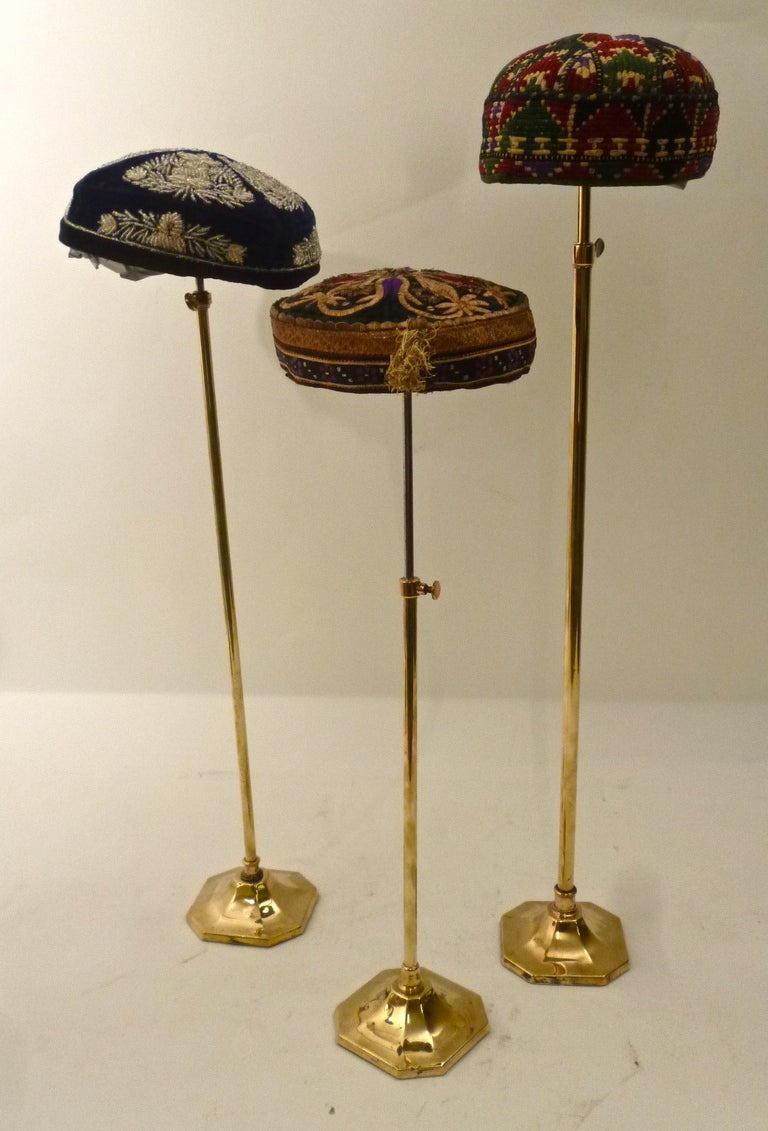 Collection of thirteen early 20th century hats from Uzbekistan and
Turkmenistan (Uzbek , Tashkent, Lakai, Tekke, Karakalpak)
and a collection of wooden and brass Victorian hat stands, circa 1860.
The hats vary- some are richly decorated with