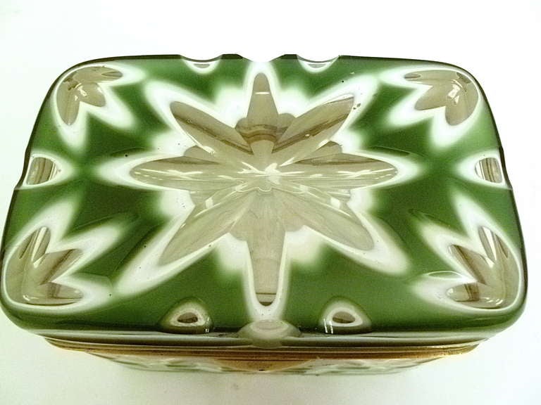 A stunning opaque green glass casket with cut design revealing white and clear glass. With delicate gilt bronze mounts, Bohemian c1880.
