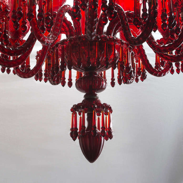 Magnificent Pair of ruby red glass twelve light chandeliers of exceptional quality, commissioned from craftsmen in India. Designed in the mid Georgian style, with twelve scrolled branches mounted with etched glass bell shaped storm shades, suspended