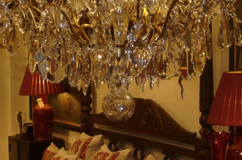Large French gilt bronze birdcage frame chandelier, with crystal plaquettes, central column and finials.