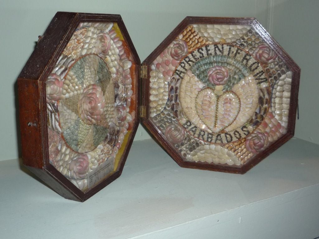 A 19th century double octagonal sailor's valentine 
within a hinged mahogany frame with latch, decorated with a variety of shells, on the right a circular motif with a heart at the centre, inscribed with 'A Present from Barbados', and on the right,
