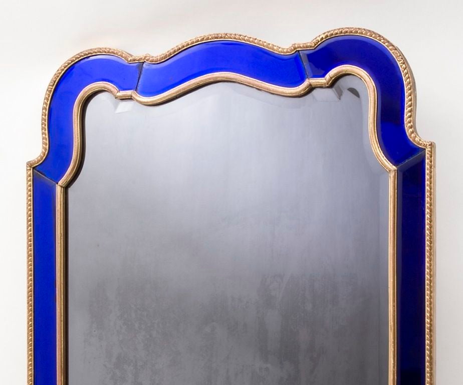 Edwardian shaped arch top mirror with blue glass panels and giltwood edging, c1900<br />
With original bevelled mirror plate