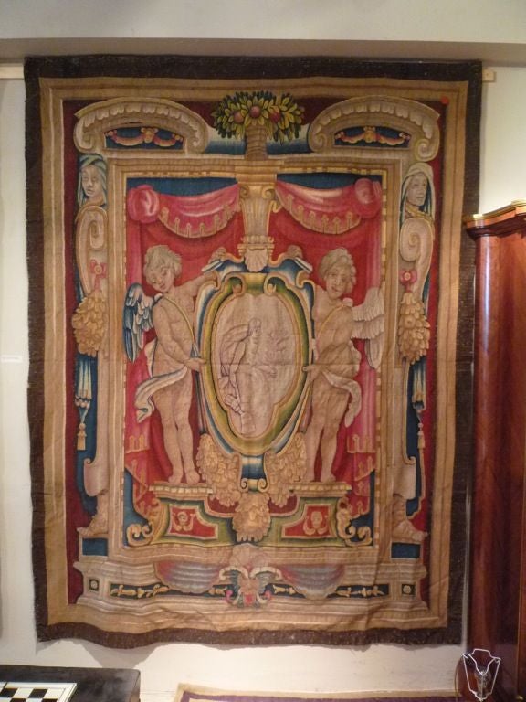 Pair of Italian Baroque Armorial Tapestries with Winged Putti holding Shields, within an Elaborate Frame - Tuscany, Italy. Late 16th Century