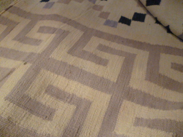 Indian cotton Dhurry with beige Greek frieze border on Two sides

and checked center pattern In Beige, Dark Indigo, lavender and Taupe.

Traditionally used in India as large floor coverings for social or formal gatherings. 

In some parts of