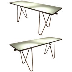 A  pair of console tables with green geometric laminate tops