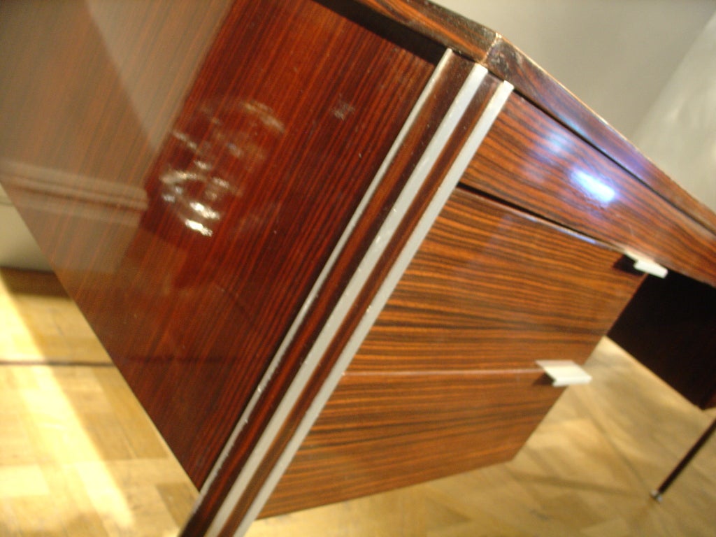 A Palisander and White Metal Desk with Three Drawers.