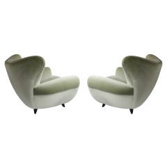 A pair of upholstered armchairs Italian c 1950 Attributed Ulrich