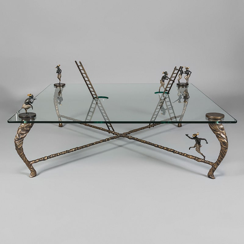 Four foot square centre table made in cast bronze and glass by Nick Davis, England, 2013. Limited edition of 5 with 3 APs.

The table is lost wax cast bronze finished with pure silver patina and 24 carat gold leaf. It depicts a mythical scene with