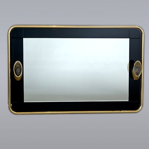 Brass-framed mirror with black glass border and two sidelights.
