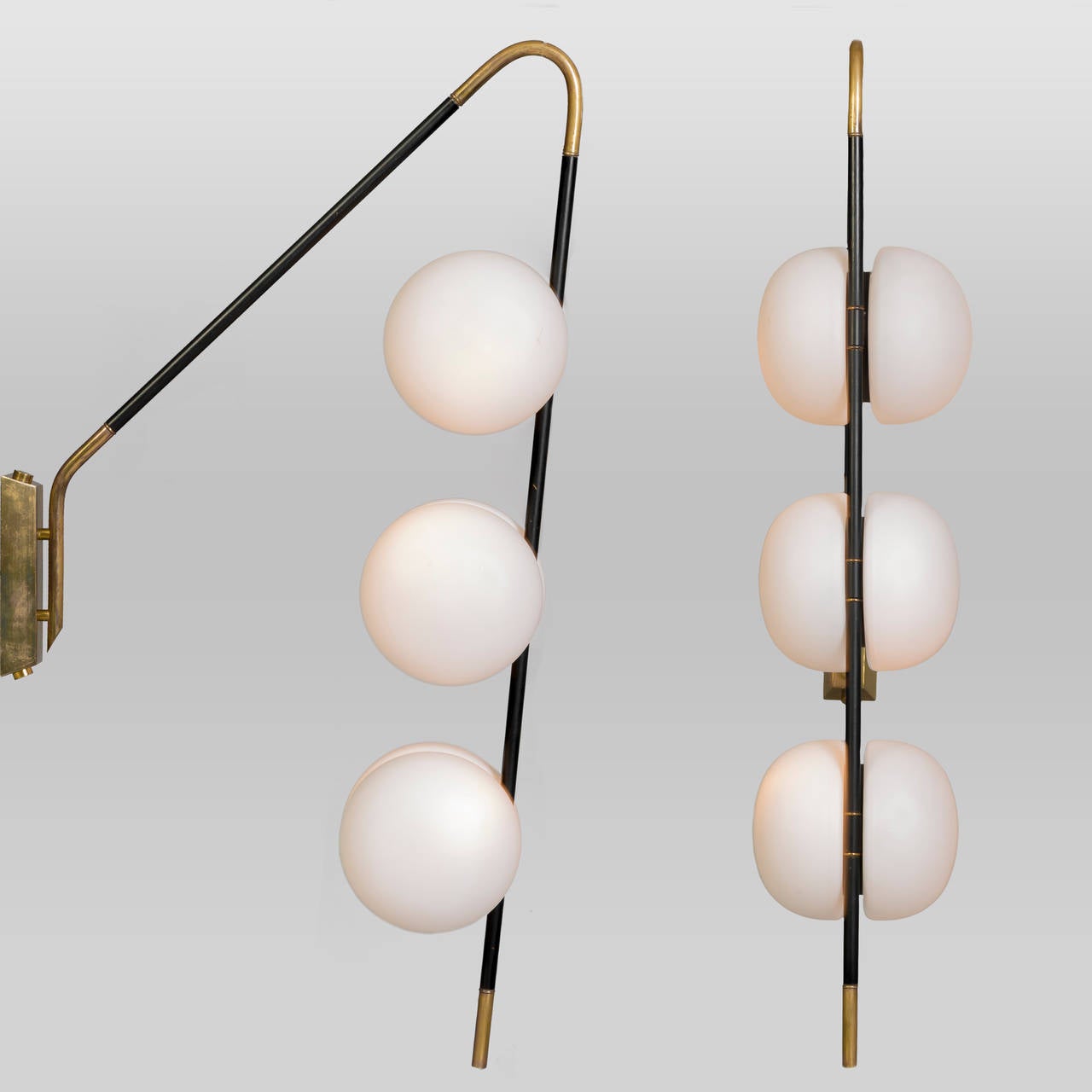 Rare pair of Lunel wall lights with their original opaline globe glass shades by Lunel Lumiere, French, circa 1950.

The brass arms are sheathed in a black metal sleeve, and the lights have just been re-wired.