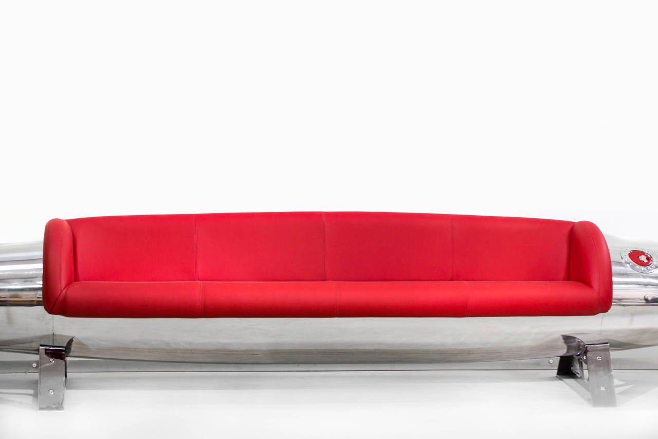 A7 Corsair drop tank red leather sofa, England, 2014.

This sofa was created from one of a pair of very rare drop wing fuel tanks from an A7 Corsair, found in Yakima, Washington. After the removal of decades of paint layer, the exposed aluminium
