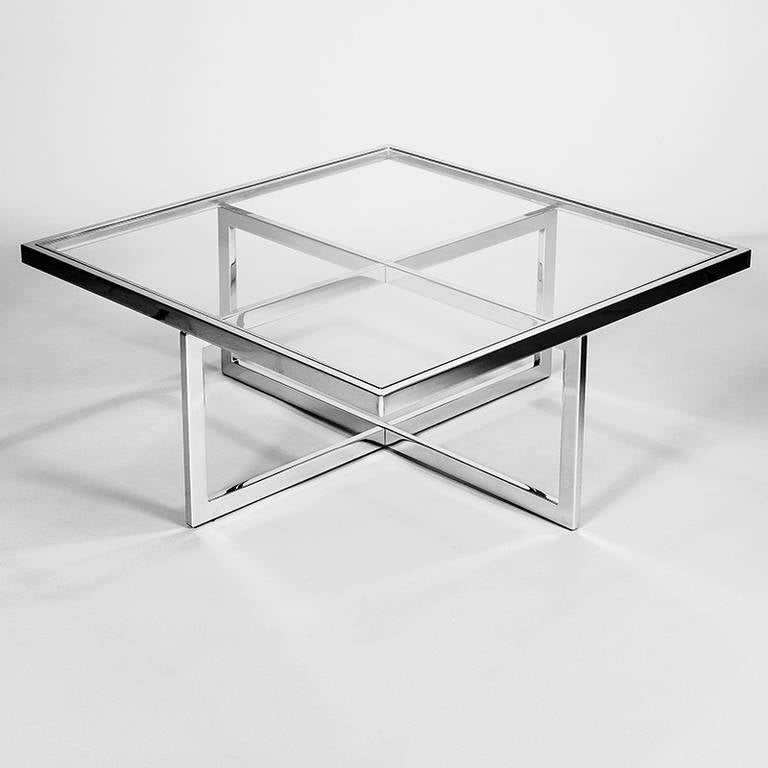 A chrome and clear glass large coffee table with decorative brass-plated steel supports under the glass, Italia, 1970s.