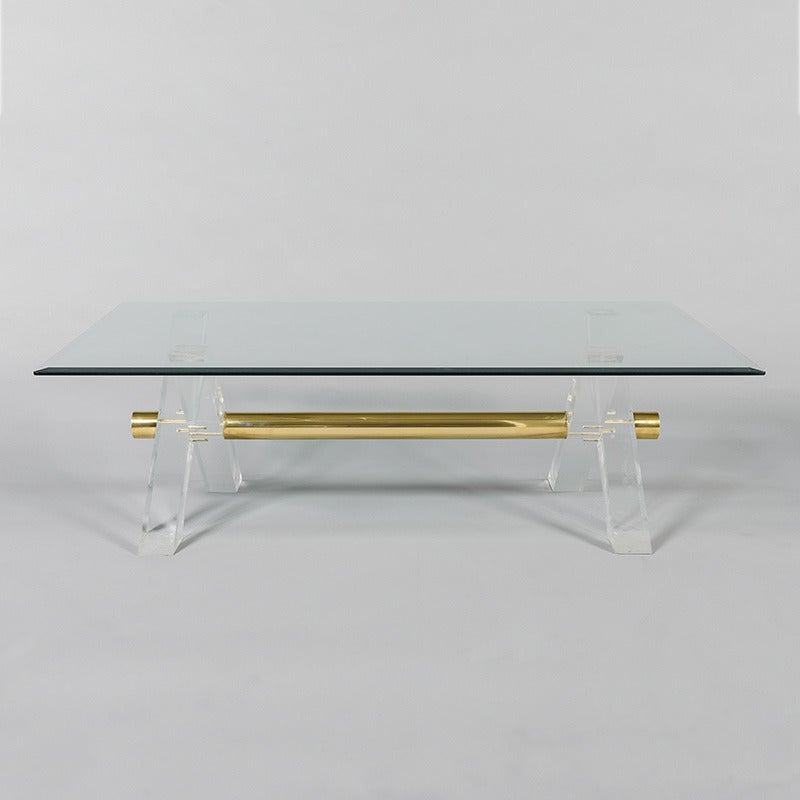 1970s glass topped coffee table with perspex legs and brass details, France.