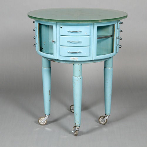 Enameled rotating dentist`s 'Girator' cabinet c1940/50s with bowed glass doors and drawers, swivelling cabinet and glass top.<br />
<br />
When we purchased this amazing trolley, we were informed that it was 1930s, but we do think it is slightly