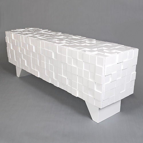 This sideboard, currently a unique piece that Decoratum commissioned, is shown in a striking monochromatic white; the contrast is provided by the shadows cast by the multiple raised lacquered blocks.

The exterior is finished in a high gloss and