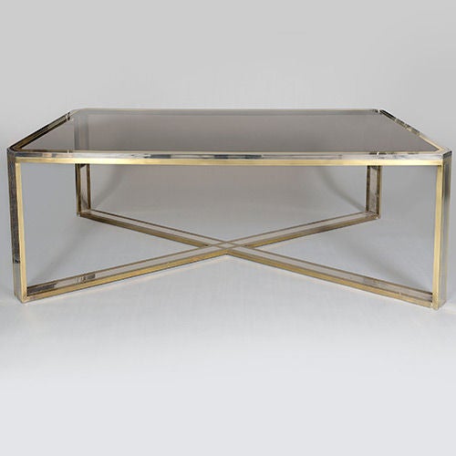 Chrome and brass dining table by Romeo Rega, Italy, 1970s.

The unusual crossed stretchers are typical of Rega applying his own 'twist' to a classic dining table design.