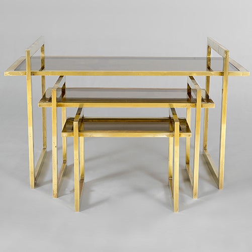 Set of three brass nesting tables, Italy, c1950s with smoked glass tops.

Medium: 38h x 60 x 38cm
Small: 30h x 30 x 42 cm
Specifications below are for largest table.