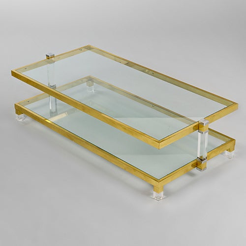 Brass and Lucite centre table, Italy, c1970s.

Unusually, this table is supported by two centre arms at either end giving it a 'lighter' feel.