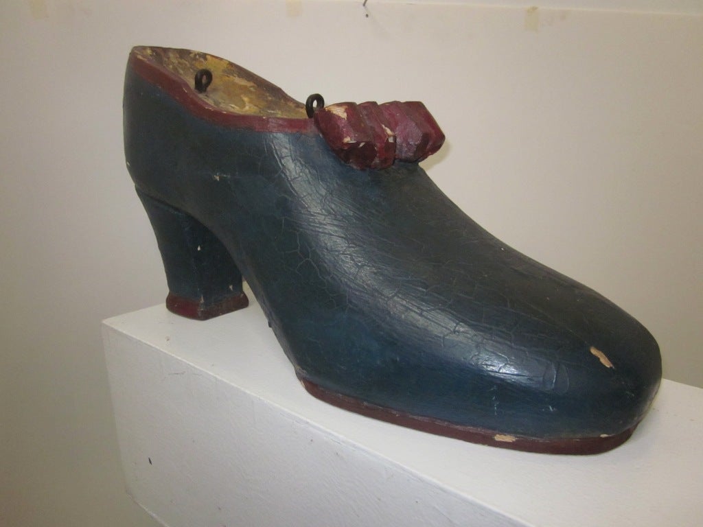carved wood shoe trade sign