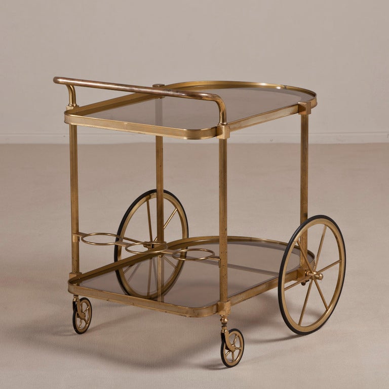 An Art Deco Inspired Brass Framed Barcart with Part Back Painted Glass Shelves 1950s

Height to Handle 72cm