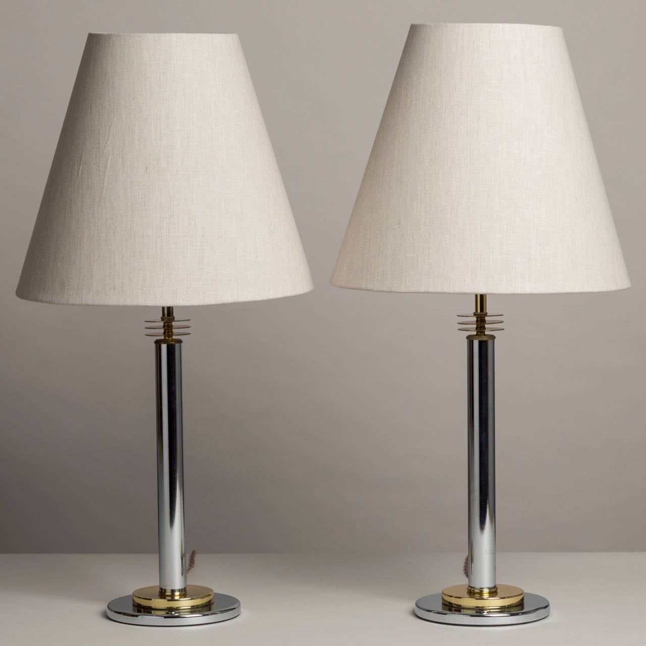 A pair of brass and nickel table lamps in the manner of Paul Evans.

Prices include 20% VAT which is removed for items shipped outside the EU.