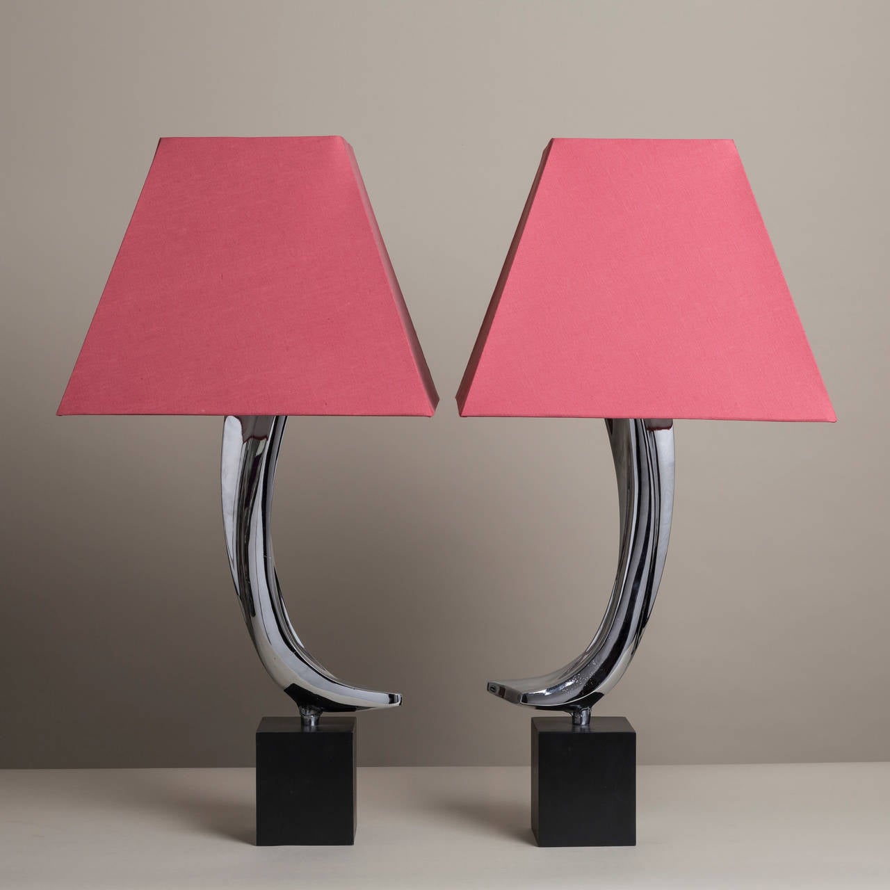 A pair of curved nickel plated table lamps on ebonised bases designed by Laurel Lamp Manufacturing Company of Newark, NJ, USA, 1960s
