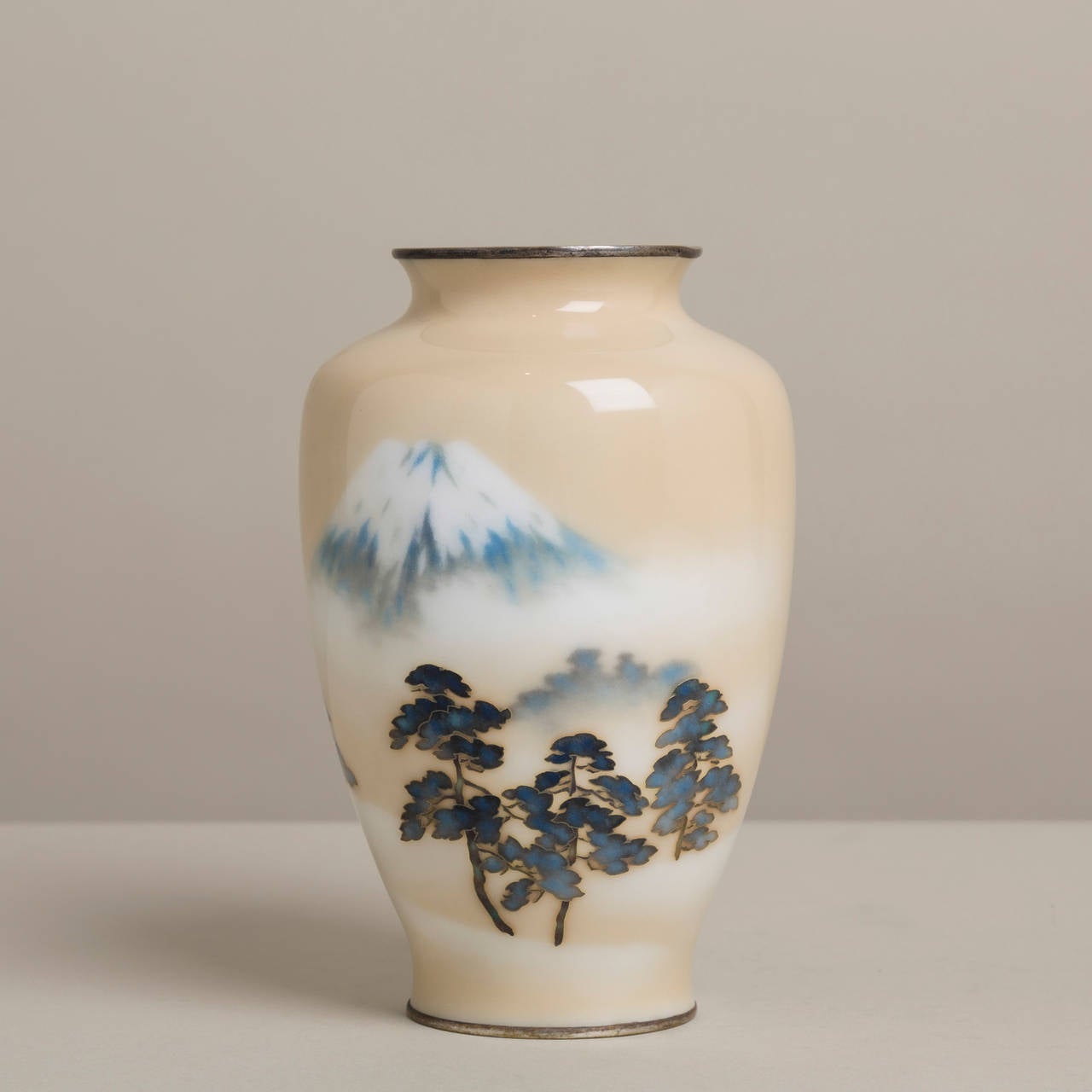 A Japanese Cloisonne´ cream enamel vase depicting Mount Fuji by Ando, circa 1930.