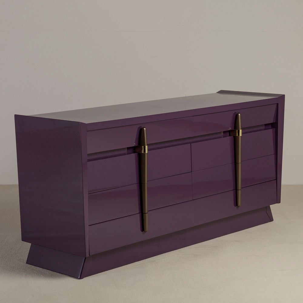 An aubergine lacquered eight-drawer commode with brass and bronze detailed painted handles 1950s, Talisman edition.