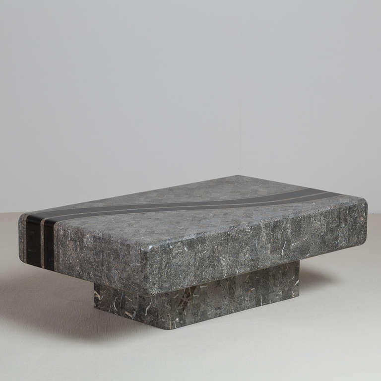 A charcoal and black tessellated stone veneered coffee table by Maitland Smith, 1980s.

Maitland Smith was established in 1979. They used highly skilled artisans and quality raw materials to create decorative accessories and furniture inspired by