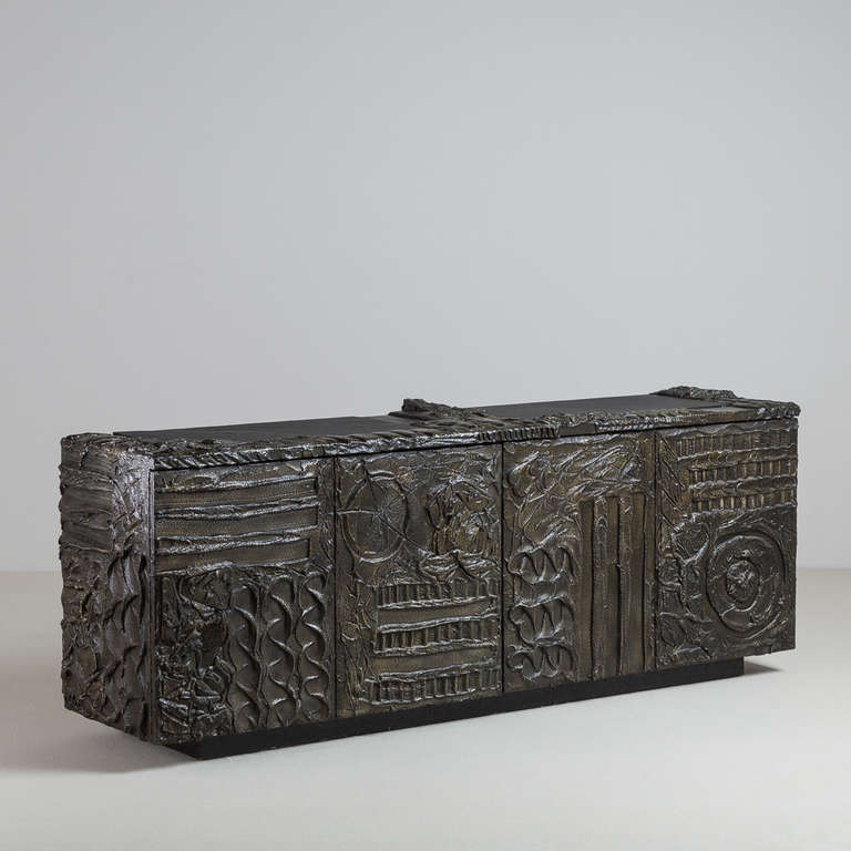 A Paul Evans designed Sculpted Bronzed Resin and Patinated Steel Four Door Cabinet USA , with Bi-folding Concertina Doors and Two Part Inset Slate Top