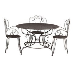 Antique A Set of Four French Patinated Iron Chairs and Circular Table