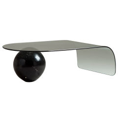 A Bent Glass Coffee Table with Large Sphere Base