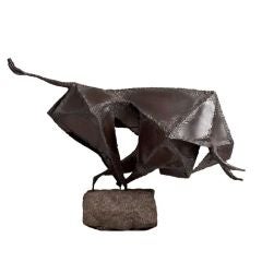 A Brutalist Metal Sculpture of a Charging Bull