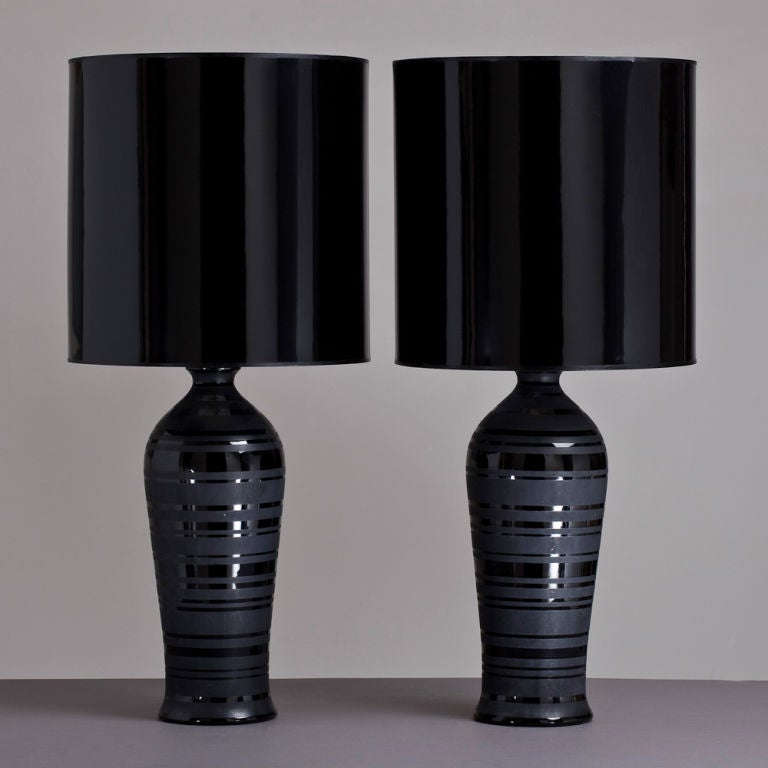 A single black ceramic table lamp with black patent shade.