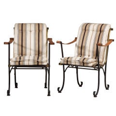 A Pair of Iron Framed Campaign Chairs with Leather Strapped Arms