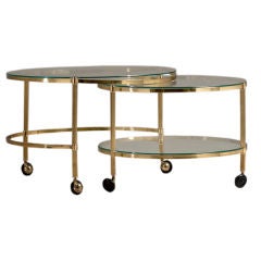 A Two Tiered, Brass Framed Swivel Extending Coffee Table