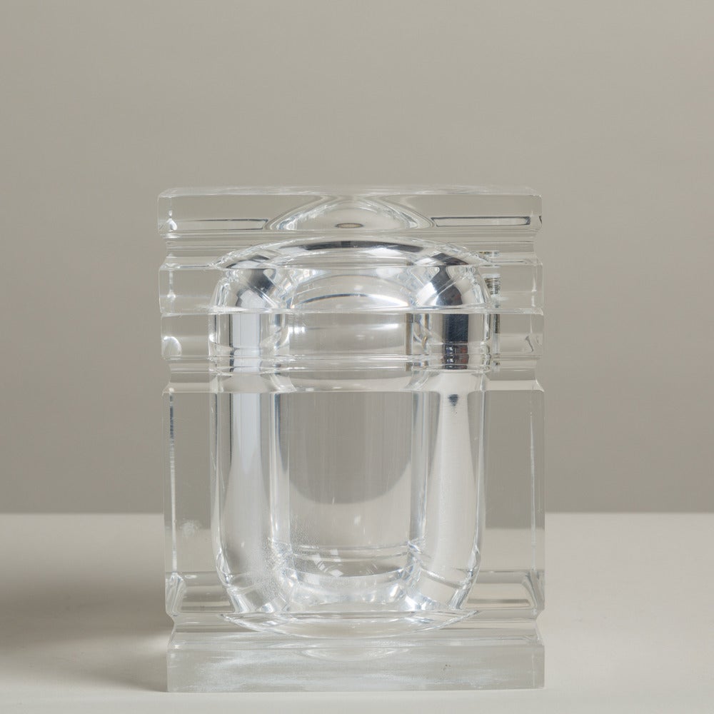 A chunky Lucite ice bucket with incised detail and a swivel top lid, 1970s.
