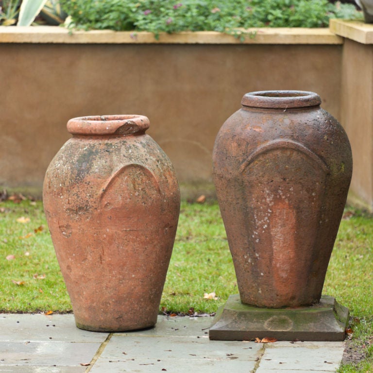 A Pair of Late 19th Century Italian Terracotta Storage Jars, one stamped Vinceno Bitossi Montelupo, one on sandstone base <br />
Shorter Jar = 80cm widest part of the Jar 46cm