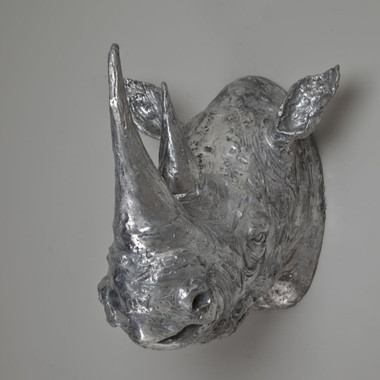 A cast aluminium rhino head by Christian Maas, signed and stamped 2/33.

Christian Maas is a French sculptor who has been sculpting since the 1980s. He is renowned for his eccentricities with risqué subject matters and life-size Animalia in eye