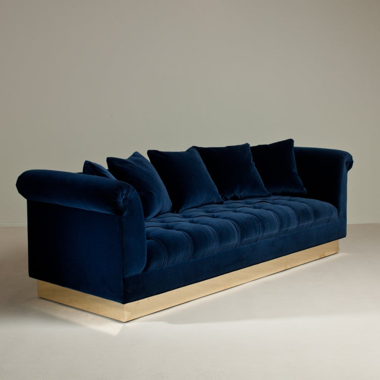 A Large Deep Buttoned Navy Velvet Upholstered Sofa on Brass Base by Talisman Bespoke. The perfect combination of elegant design and comfort, this generously proportioned deep buttoned sofa is available in a variety of fabrics and can be adapted to a