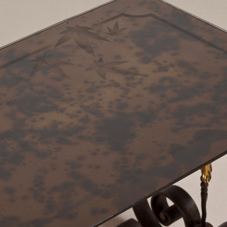 A Wrought Iron Table in the Manner of Piquet Lyon, France with polished brass detail and a leaf motif Top circa 1925