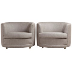 A Pair of Barrel Back Armchairs on Brass Castors