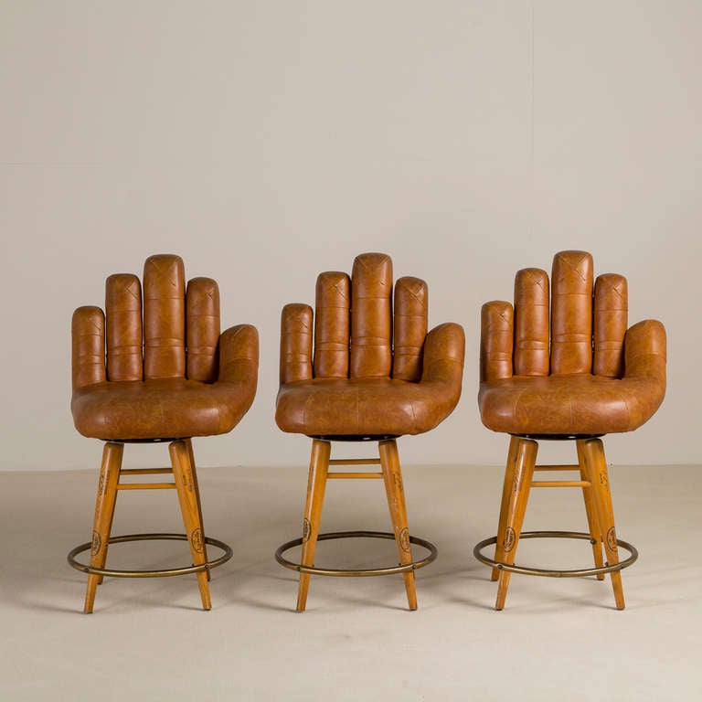 A Set of Three Leather Upholstered Baseball Glove Swivel Bar Stools stamped Fred Lynn Louisville Slugger