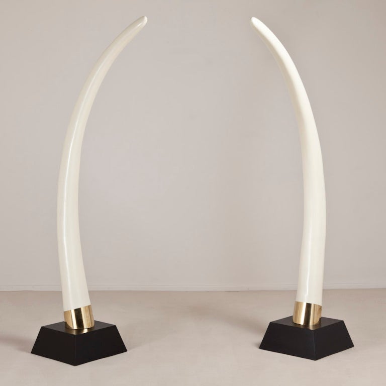 A Pair of Faux Elephant Tusks on Ebonised Bases with Brass Collars 1970s, Talisman Edition
