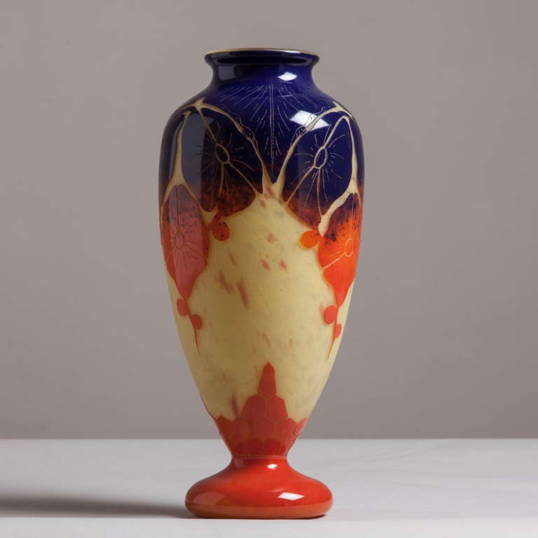 A cameo glass vase in orange, deep blue and yellow tones by Schneider from their Le Verre Francais period (1918-1932) Signed.

Schneider Glass was a French company founded by brothers Ernest and Charles Schneider in 1917.  They introduced many deco