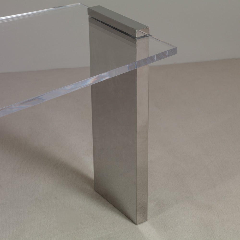 A large sculptural lucite and steel pedestal ended desk 1970s

Footprint width 167cm (65.7