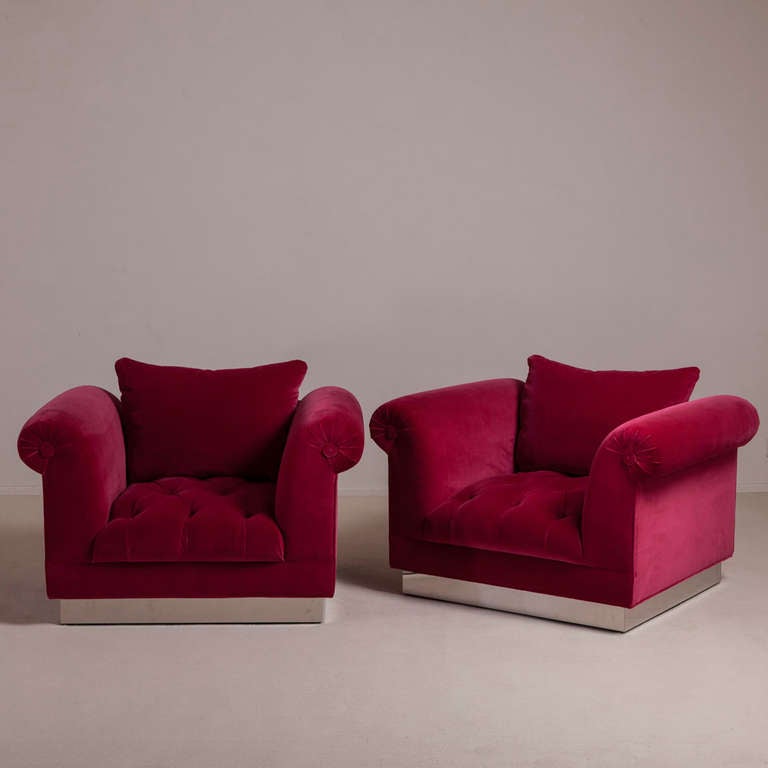 A Standard Pair of Deep Buttoned Cranberry Velvet Upholstered Armchairs on Steel Bases by Talisman Bespoke. 

These large and inviting armchairs, based on the popular Talisman Bespoke deep buttoned sofa, are available in a variety of fabrics and can